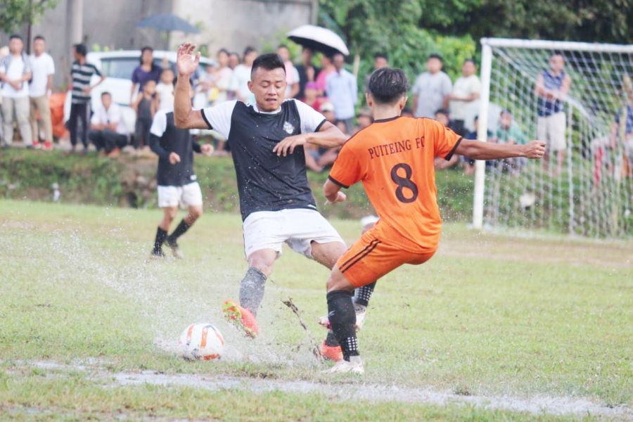 Match in action between Puiteing FC (Orange) and Lekie Mtei FC (black & white). (Photo Courtesy: PDFA)